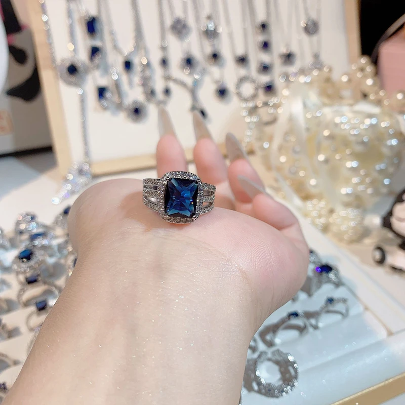 Elegant halo design crystal blue ring